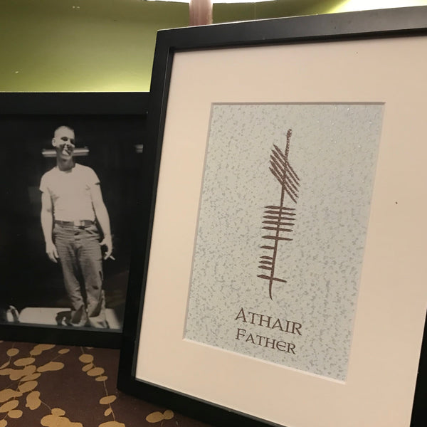 Father Ogham print on table with black and white photo of a man