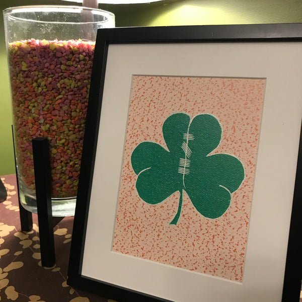 Painting of a shamrock with Ogham writing in the center